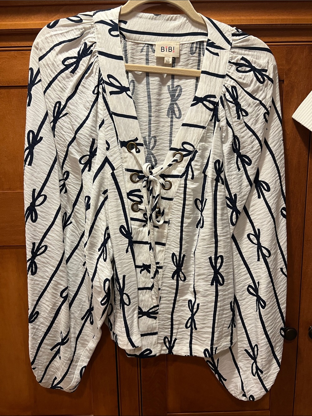 BiBi White Lace-Up Blouson Top with Navy Bow Print